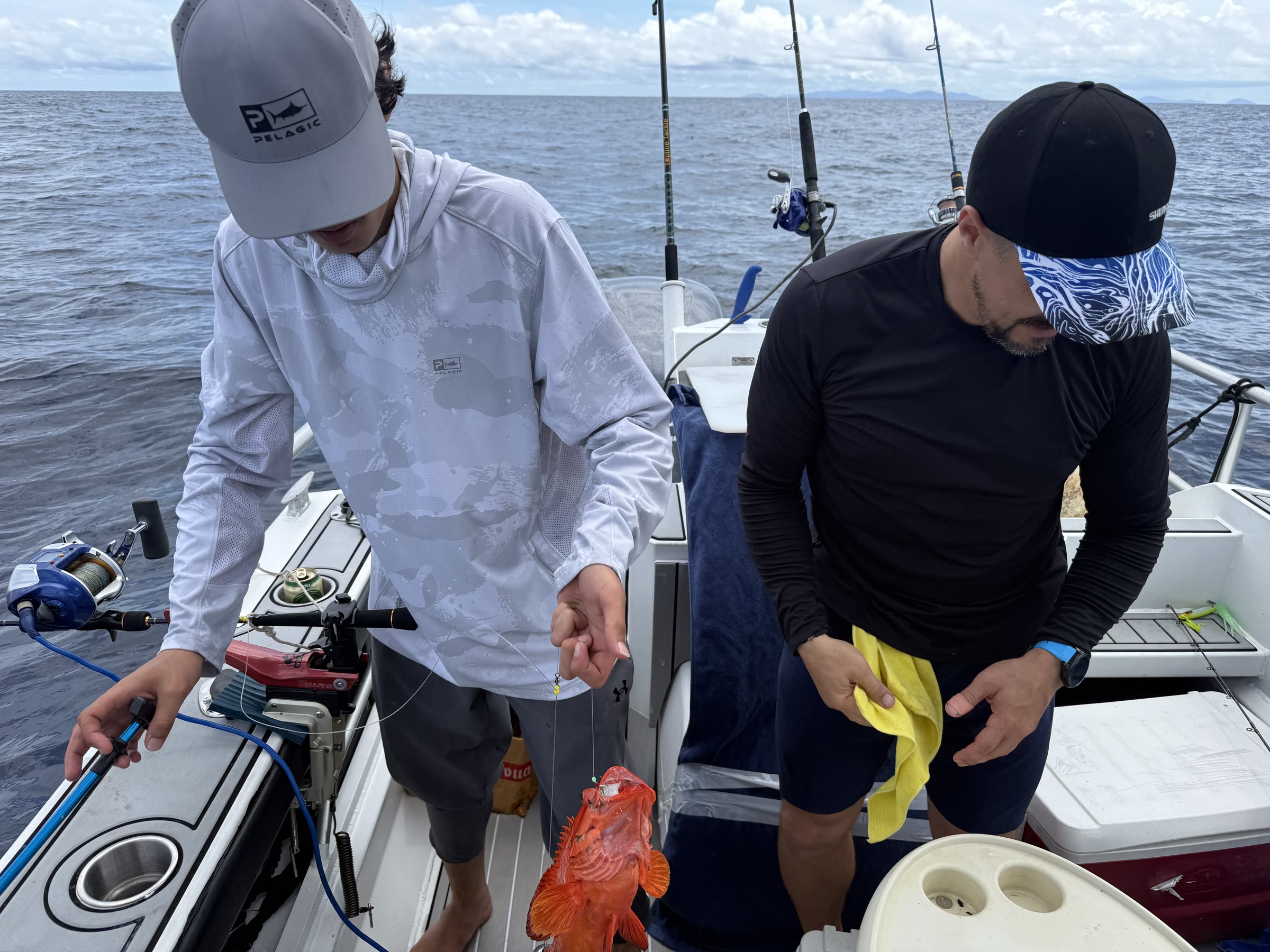 Guest holding a fresh catch aboard our yacht