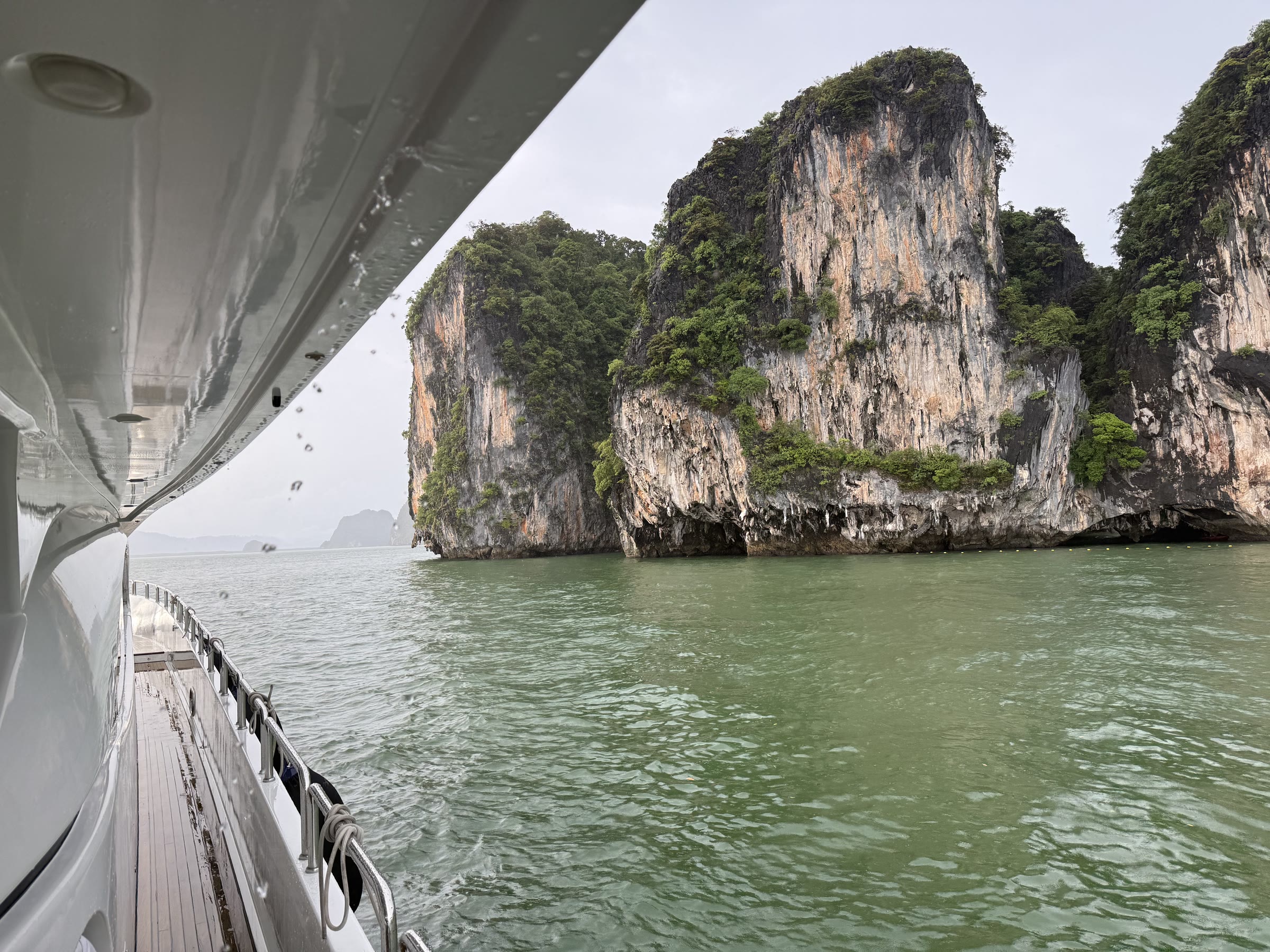 Guests on the aft deck of a yacht over the Andaman Sea