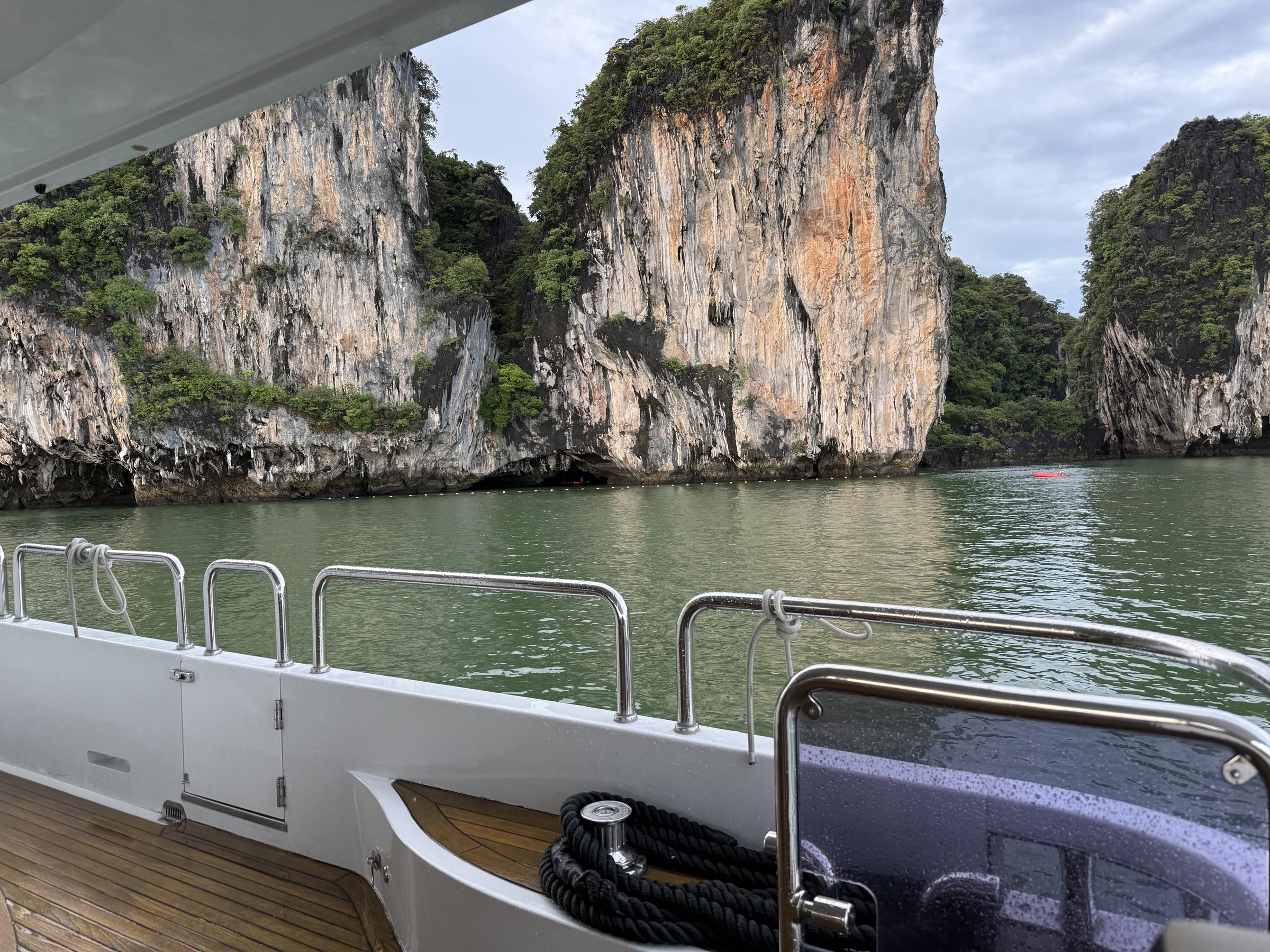 Teak aft deck of a yacht over an Andaman lagoon