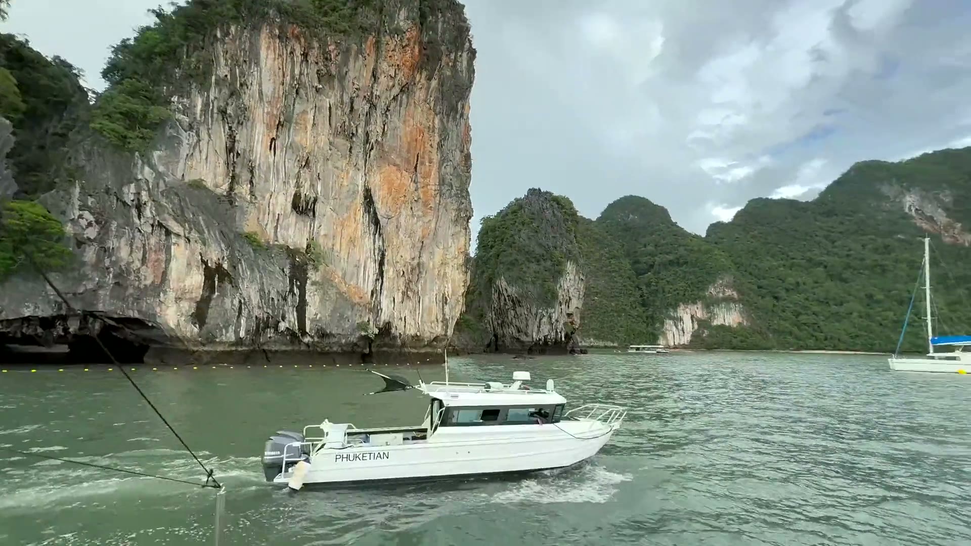 One of our boats cruising beneath the Andaman's limestone cliffs